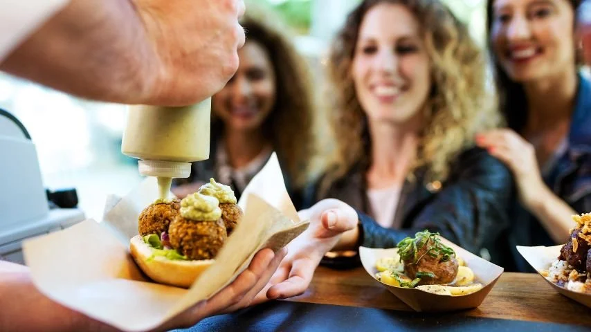 People enjoying food truck food